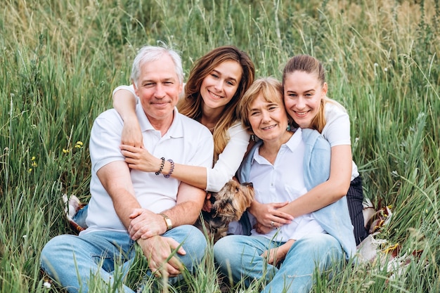 Happy senior couple with their daughters in nature