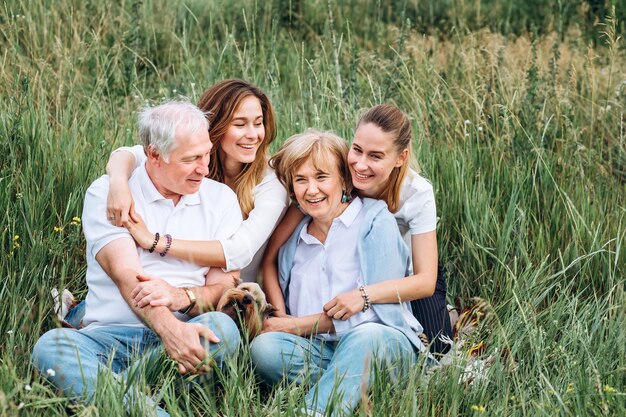 Happy senior couple with their daughters in nature