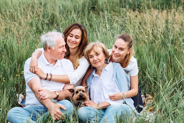 Happy senior couple with their daughters in nature