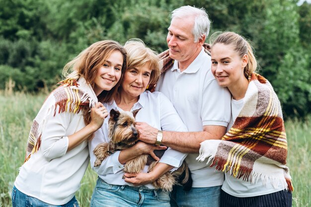 Happy senior couple with their daughters in nature