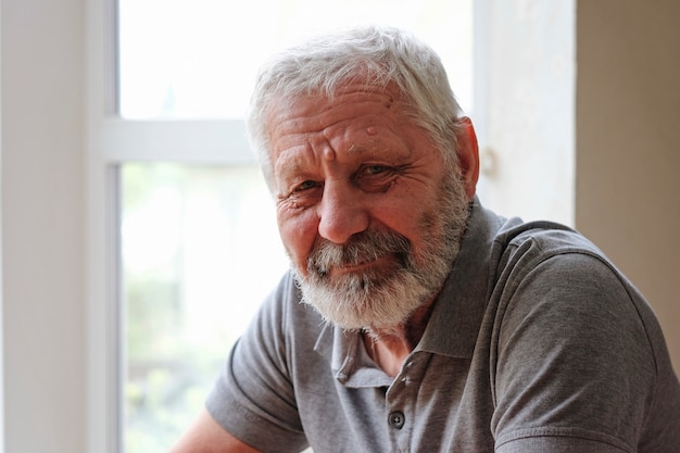 Happy Senior elderly man looking at front and smiling