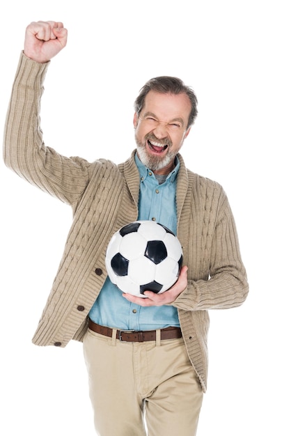 Happy senior man celebrating victory while holding football isolated on white