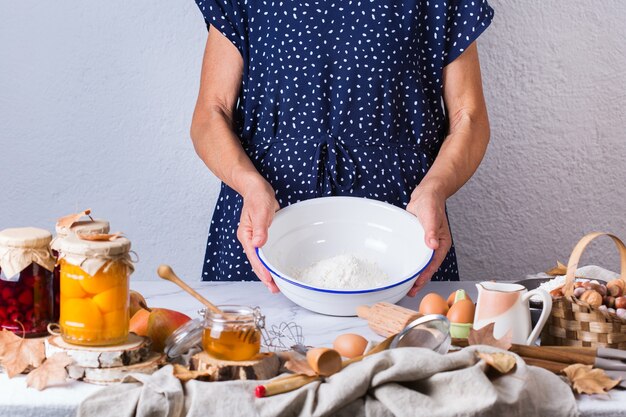 happy senior mature woman grandmother cooking kneading dough baking pie cake  cookies