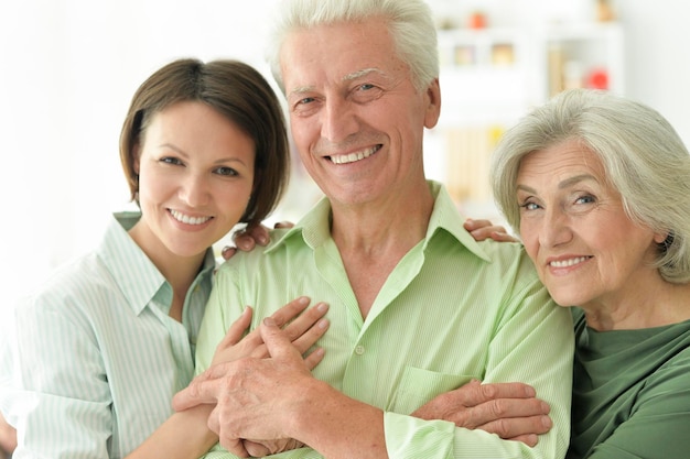 Happy senior parents with daughter at home