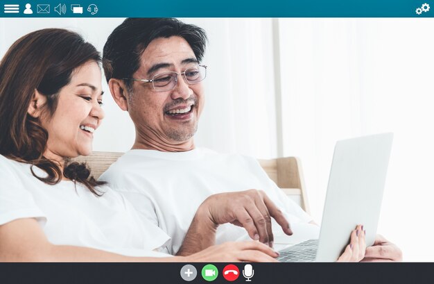 Happy senior people talking on internet video call at home