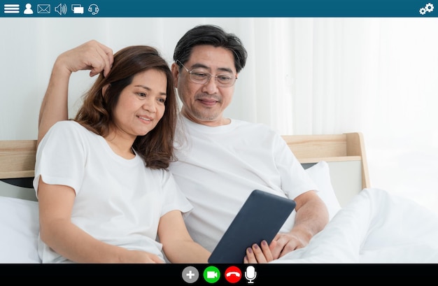 Happy senior people talking on internet video call at home