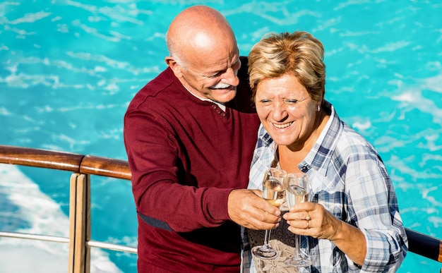 Happy senior retired couple having fun outdoors at travel\
vacation