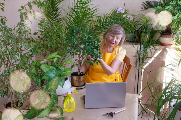 Happy senior woman blogger takes orders online Home gardening