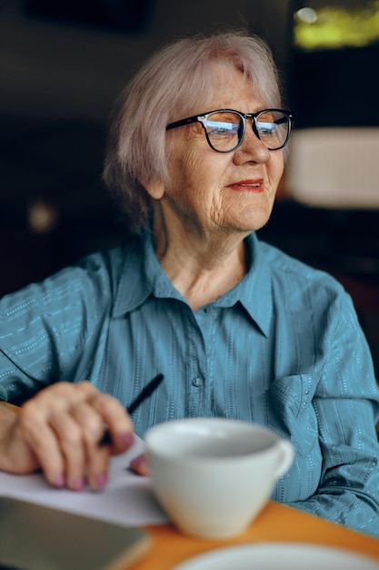 Happy senior woman documents work sheet of paper and pen lifestyle unaltered