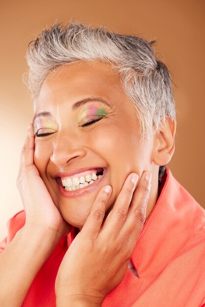 Happy senior woman and eye makeup face and cosmetics for beauty wellness and skincare against beige studio background Elderly model smile cosmetics and happiness with facial care and mockup