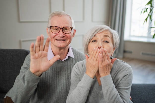 Photo happy senior woman man talk on video call with friends family mature old grandmother grandfather