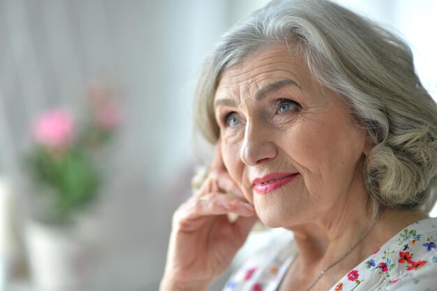 Happy senior woman posing at home