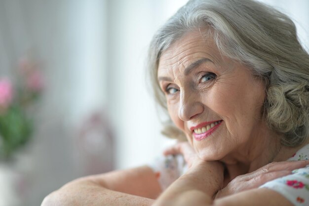 Happy senior woman posing at home