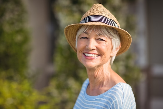 Happy senior woman in straw hat