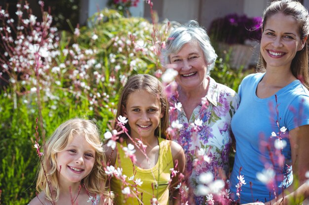 Happy senior woman with daughter and girls in back yard