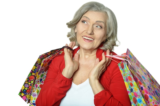 Happy senior woman with shopping bags and credit card