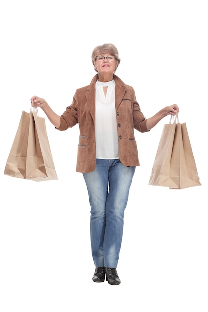 Happy senior woman with shopping bags on white background