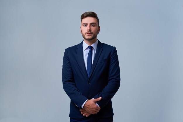 Happy serious handsome young caucasian businessman Studio shot