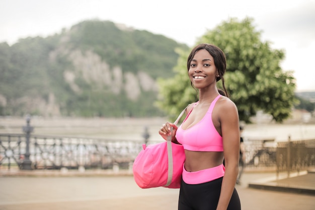 Happy sexy Afro girl in fitness outfit