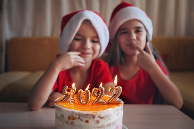 Happy sibling before christmas cake with numbers family new year celebration festive background