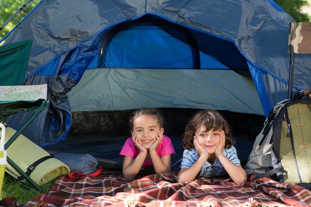 Happy siblings on a camping trip