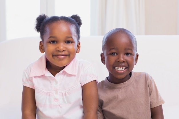 Happy siblings smiling at camera together