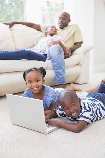 Happy siblings using their laptop