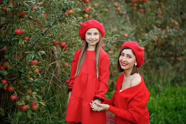 Happy single mother picking fresh vegetables with her daughter