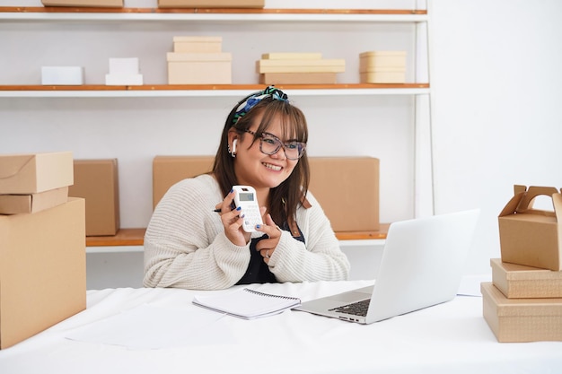 happy small business owner having an online meeting in a warehouse Video calling business partner
