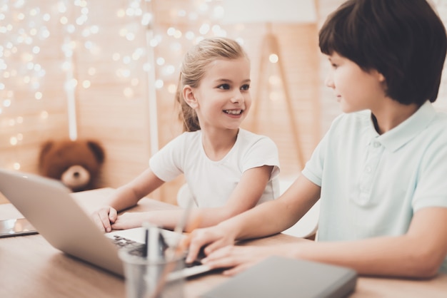 Happy Smart Kids huiswerk op de laptop.