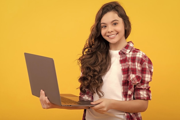 Happy smart teen girl hold laptop during school online lesson wireless technology