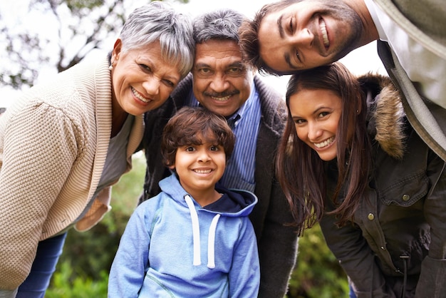 Happy smile and portrait of a big family in nature on adventure travel or journey together Love bonding and boy child with his grandparents and parents while on holiday weekend trip or vacation