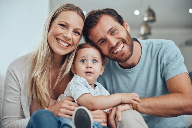 Happy smile and portrait fo family on sofa for bonding affectionate and quality time Relax support and care with face of parents and baby in living room at home for calm health and happiness