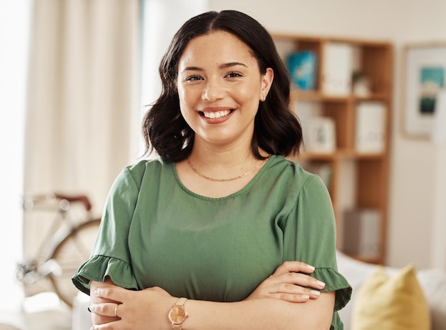 Happy smile and portrait of woman with her arms crossed in the living room for confidence at home Happiness face and headshot of young female person standing in the lounge of her modern apartment