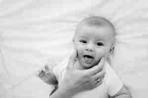 Photo happy smiling 5 months baby boy close up portrait on white background looking at mother intersesting