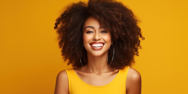 Happy smiling african american young woman on a yellow background