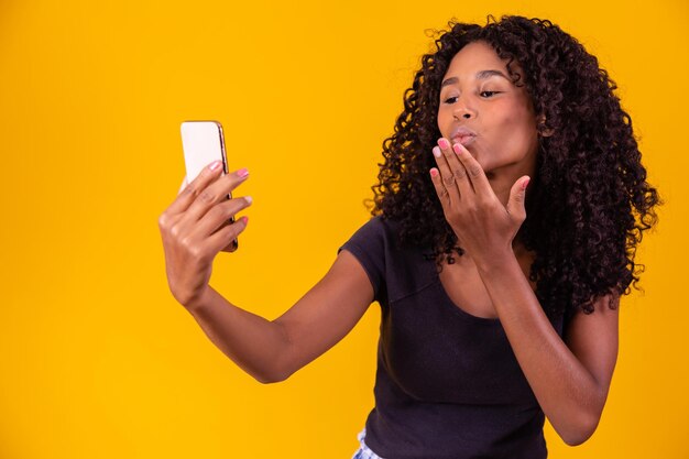 Happy smiling afro girl on a smartphone video call