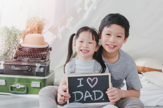 Happy smiling Asian daughter and son 