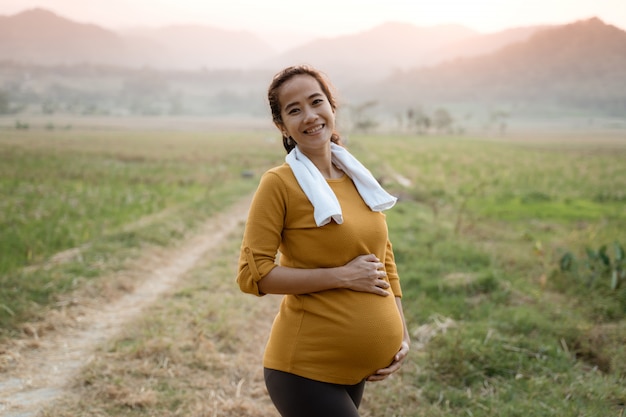 Happy smiling asian pregnant woman exercise