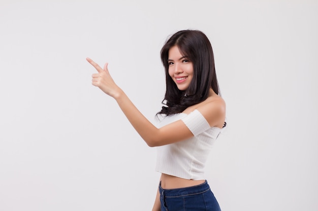 Happy smiling asian woman pointing up