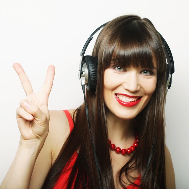 Happy smiling beautiful young woman showing two fingers or victory gesture