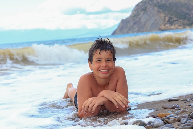 Happy smiling boy on the sea beach