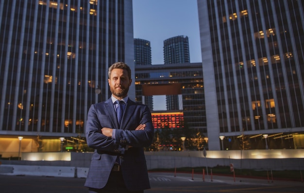 Photo happy smiling businessman in suit near office successful employer to make a deal while standing near