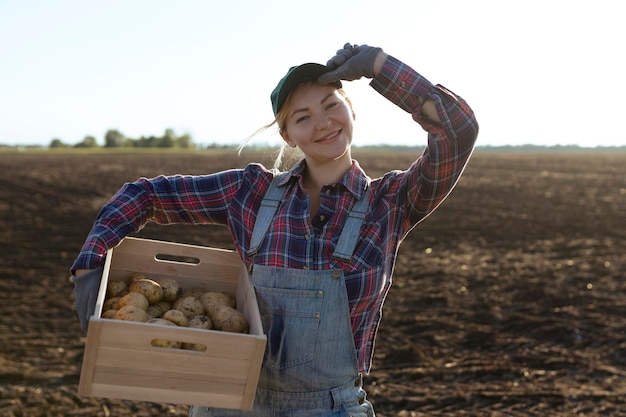 Happy smiling caucasian female potato farmer or gardener Agriculture food production harvest concept