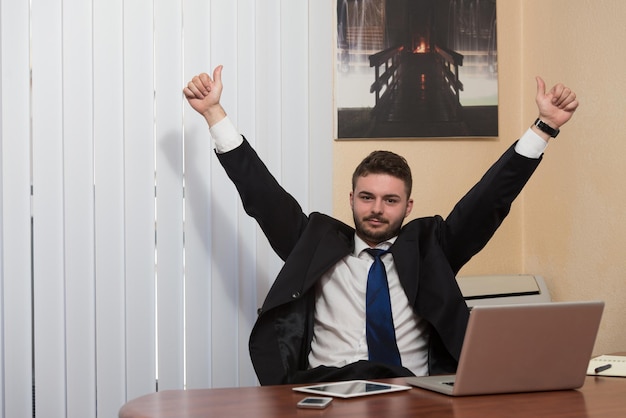 happy smiling cheerful business man with thumbs up gesture