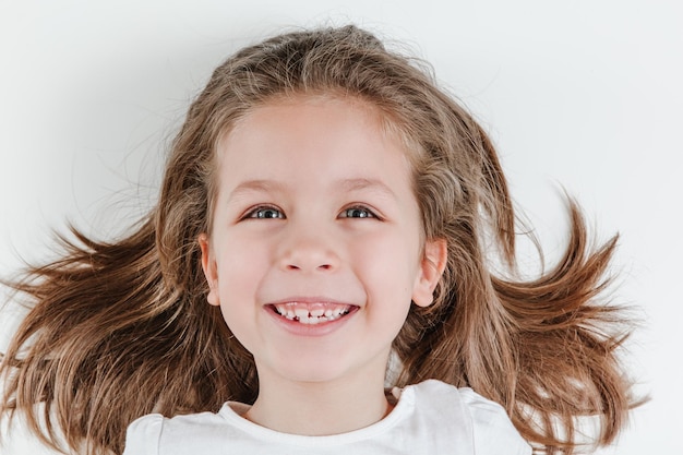 Happy smiling child portrait on the white background Little todler attractive lovely curious