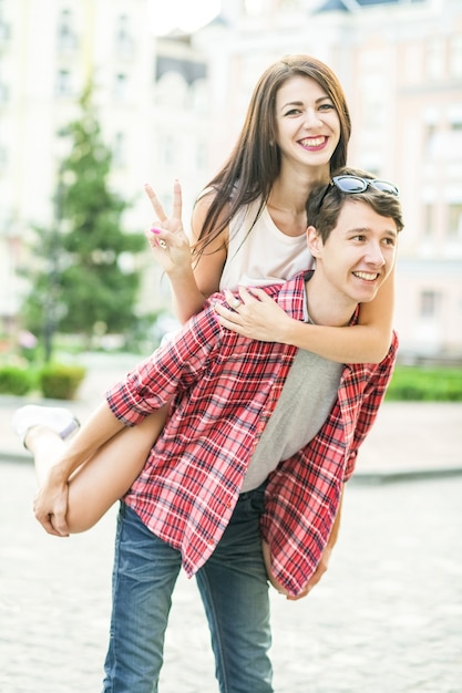 Happy smiling couple having fun in the street on summertime