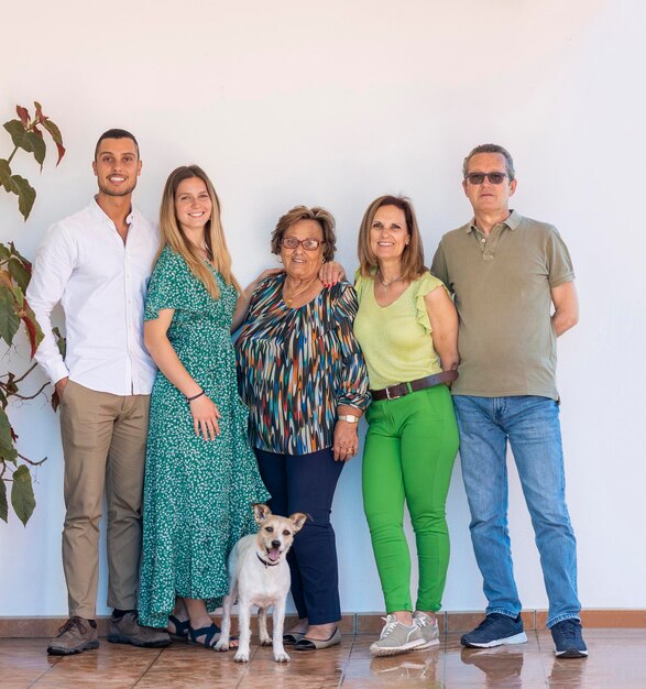 Happy smiling European family with puppy dog over white background