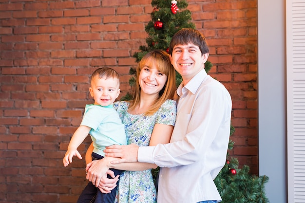 Happy smiling family near the Christmas tree