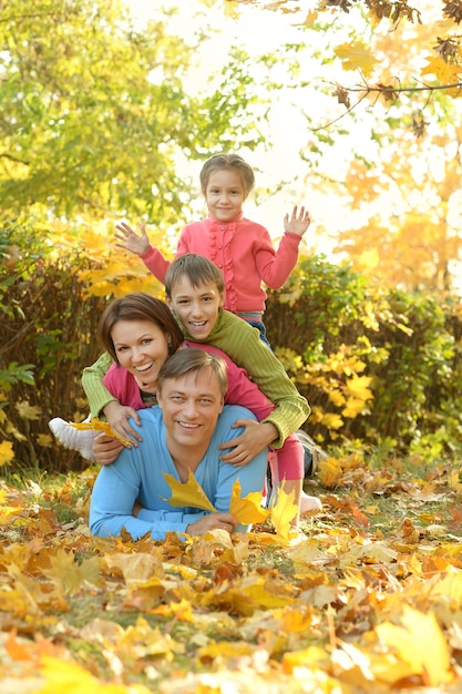 Happy smiling family relaxing in autumn park